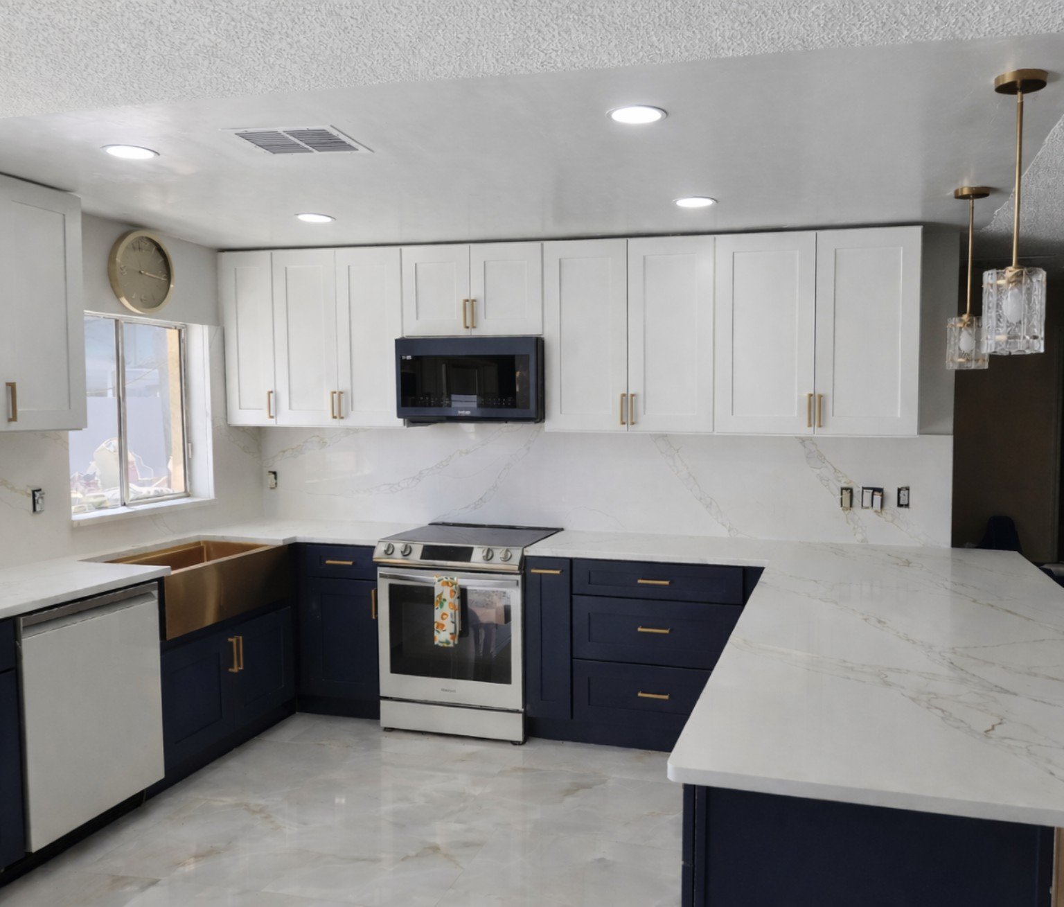 After photo of remodeled kitchen with white upper cabinets and navy lower cabinets